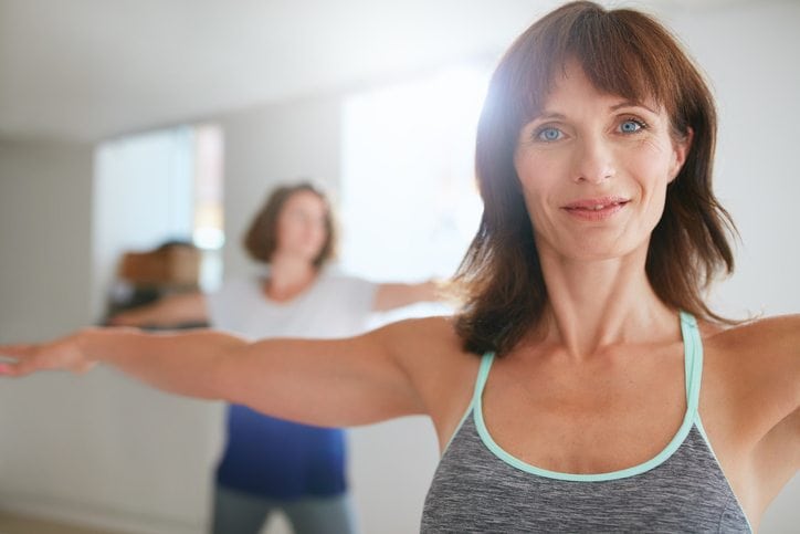 Women doing yoga workout at gym