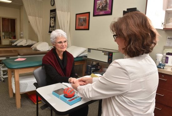Suzanne Harriman receiving hand therapy.