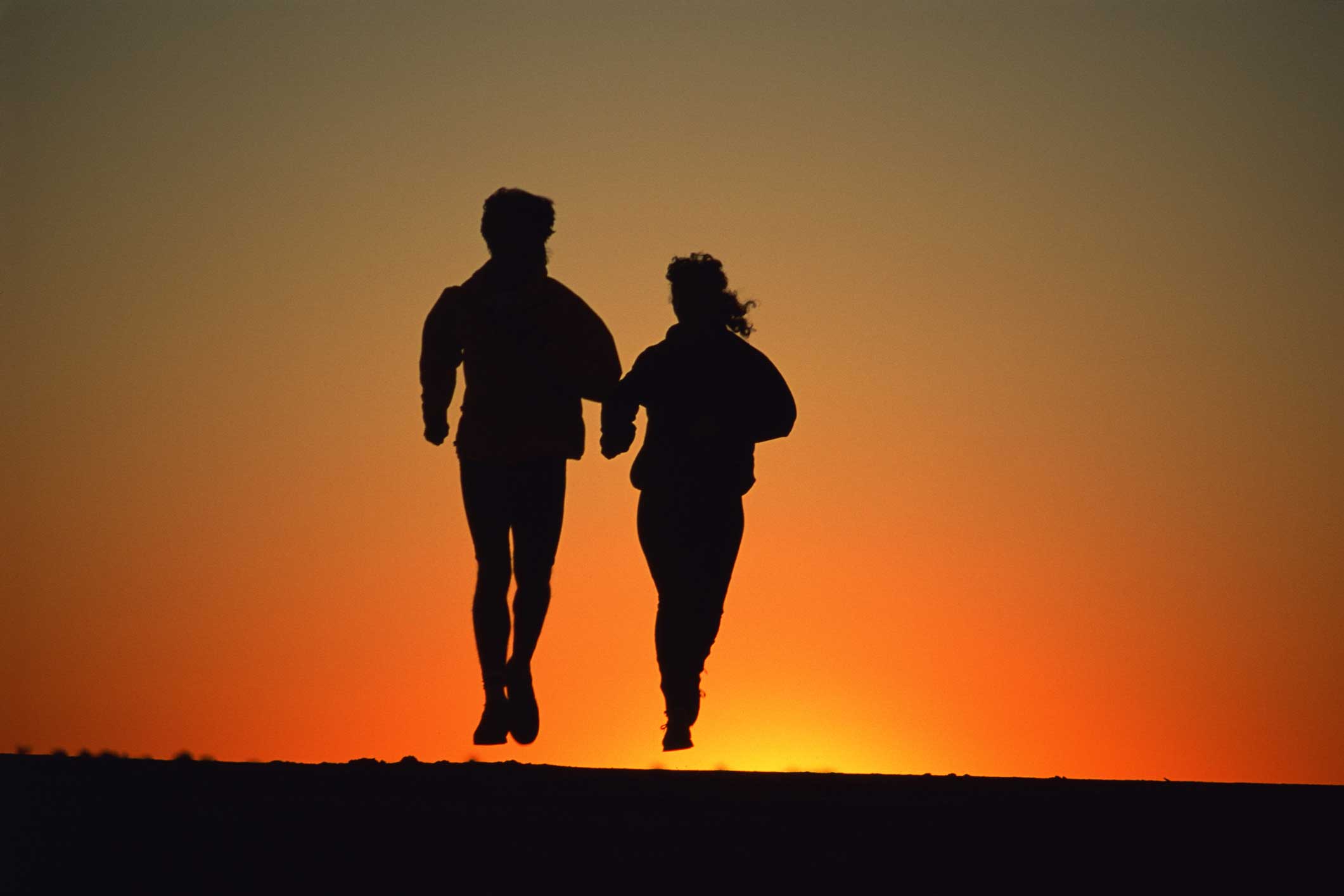 Couple jogging at sunset.
