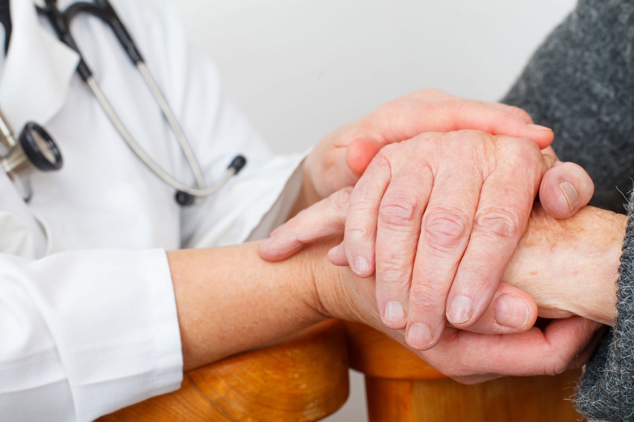 Doctor holding patient's hand