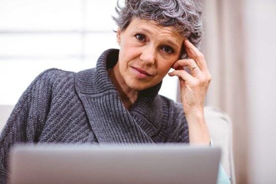 Woman sitting at laptop.