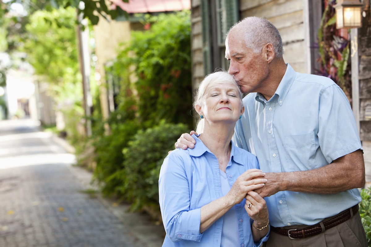 Senior man giving wife a kiss