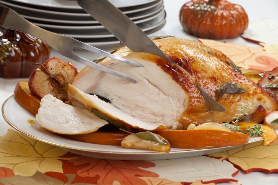 Thanksgiving Turkey breast with sage and honey rub being cut