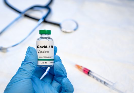 Covid-19 coronavirus vaccine vial with syringe and stethoscope