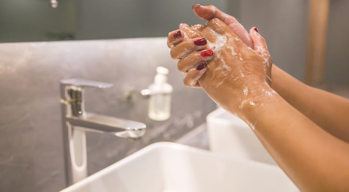 Business woman hand washing with soap to prevent Coronavirus