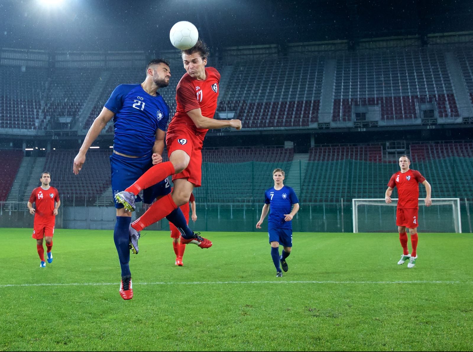 Professional soccer player heads a ball.