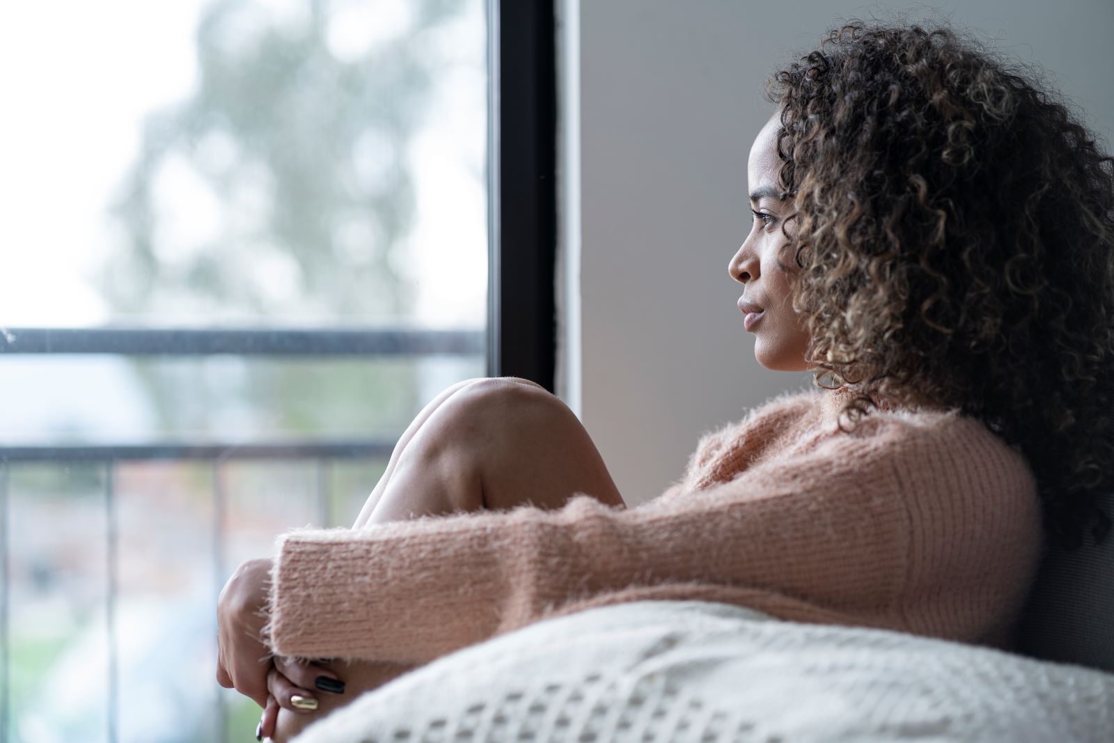 Woman looks out a window.